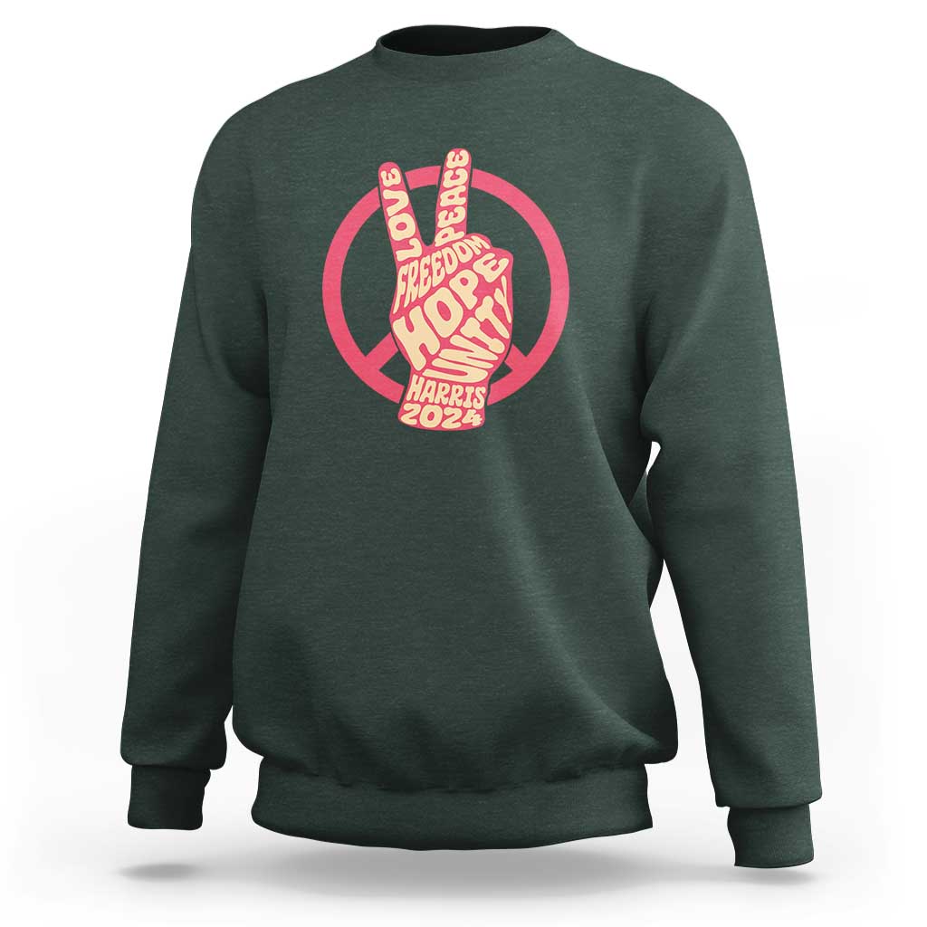 Dark green crewneck sweatshirt with red peace-sign graphic and Harris 2024 text.