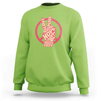 Lime green crewneck sweatshirt with red peace-sign graphic and Harris 2024 text.