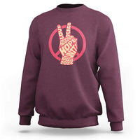 Maroon crewneck sweatshirt with red peace-sign graphic and Harris 2024 text.
