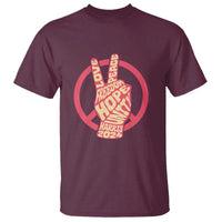 Maroon short-sleeve T-shirt with red peace-sign circle graphic and 'Harris 2024' text