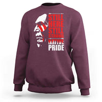 Maroon crewneck sweatshirt with Native-inspired profile graphic and red stacked text front