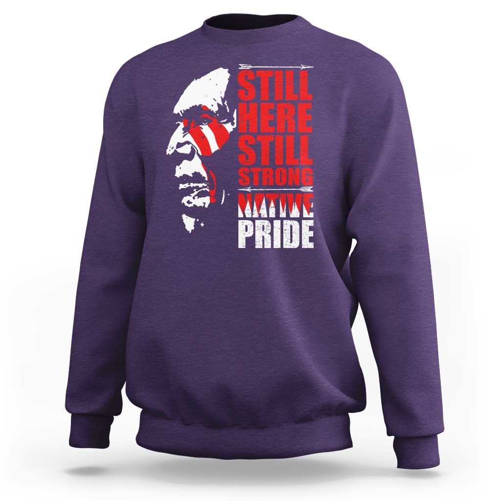 Purple crewneck sweatshirt with Native-inspired profile graphic and red stacked text front