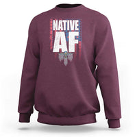 Maroon crewneck sweatshirt with centered Native-inspired graphic print and ribbed cuffs