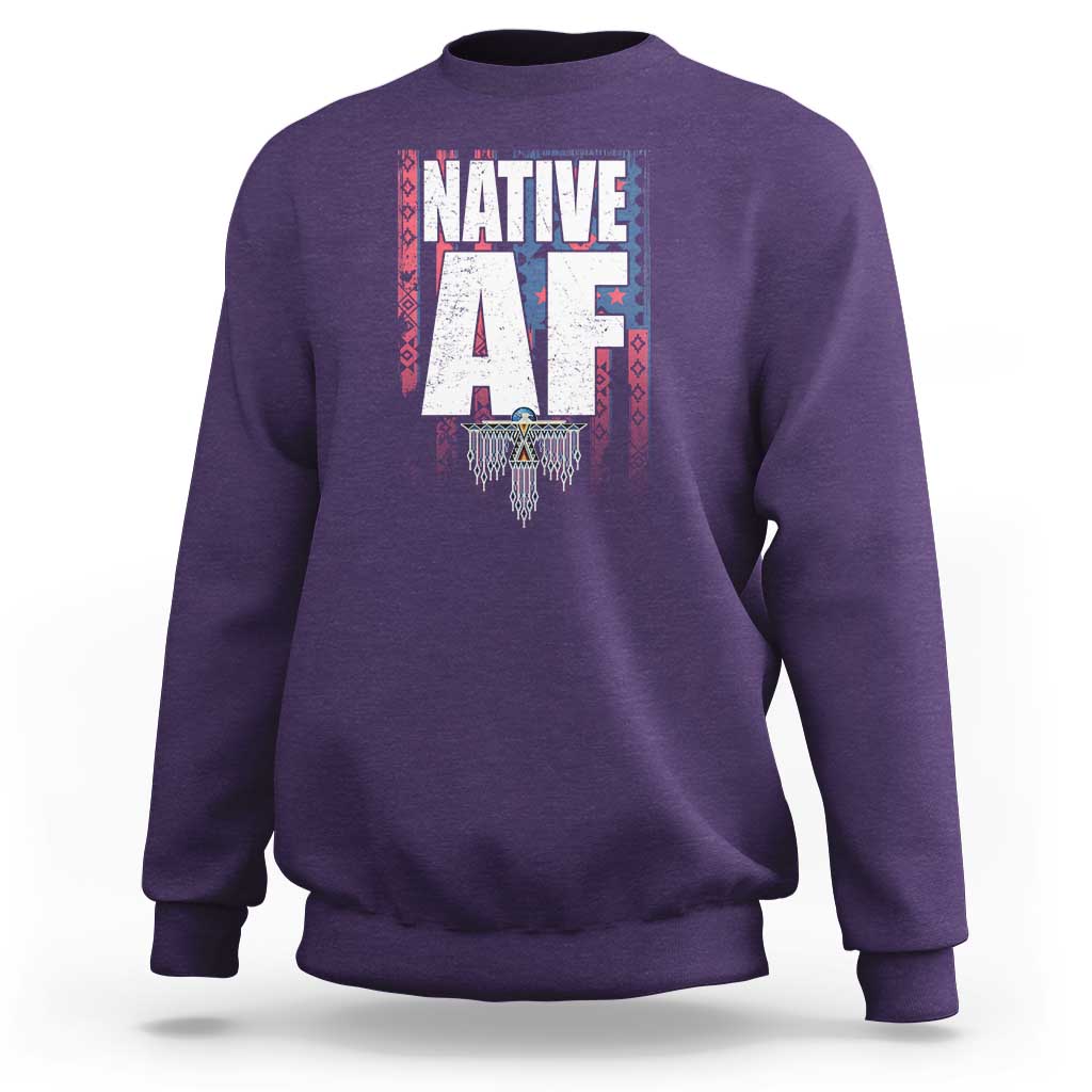 Purple crewneck sweatshirt with centered Native-inspired graphic print and ribbed cuffs