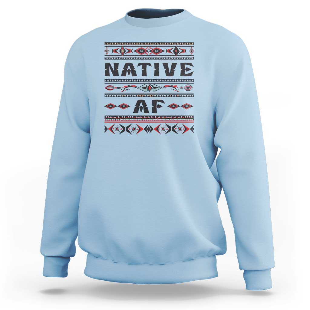 Light blue crewneck sweatshirt with bold 'Native AF' geometric tribal graphic