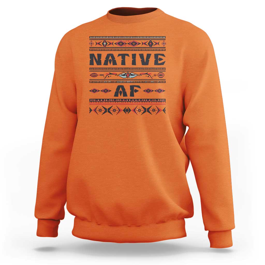Orange crewneck sweatshirt with bold 'Native AF' geometric tribal graphic