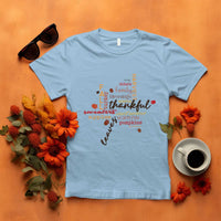 Light blue T-shirt with colorful "thankful" typography and autumn maple leaf graphic