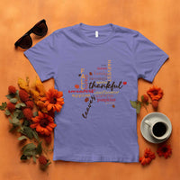 Violet T-shirt with colorful "thankful" typography and autumn maple leaf graphic