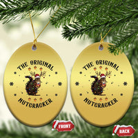 Gold oval Christmas ornaments with nutcracker squirrel graphic, shown front and back.