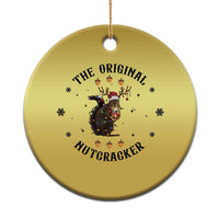 Gold round Christmas ornament with nutcracker squirrel graphic and hanging loop.