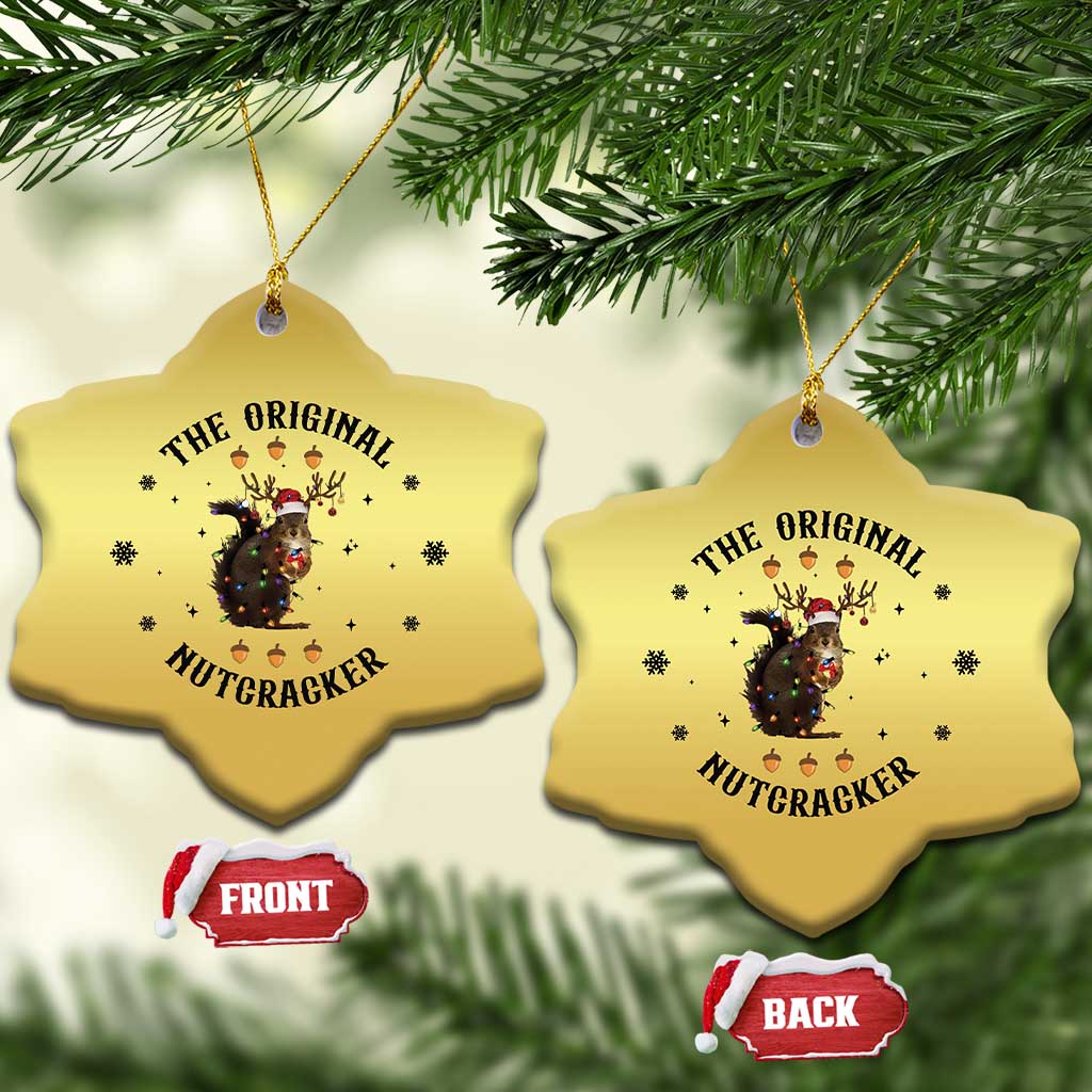 Gold heart-shaped Christmas ornaments with nutcracker squirrel graphic, two hanging.