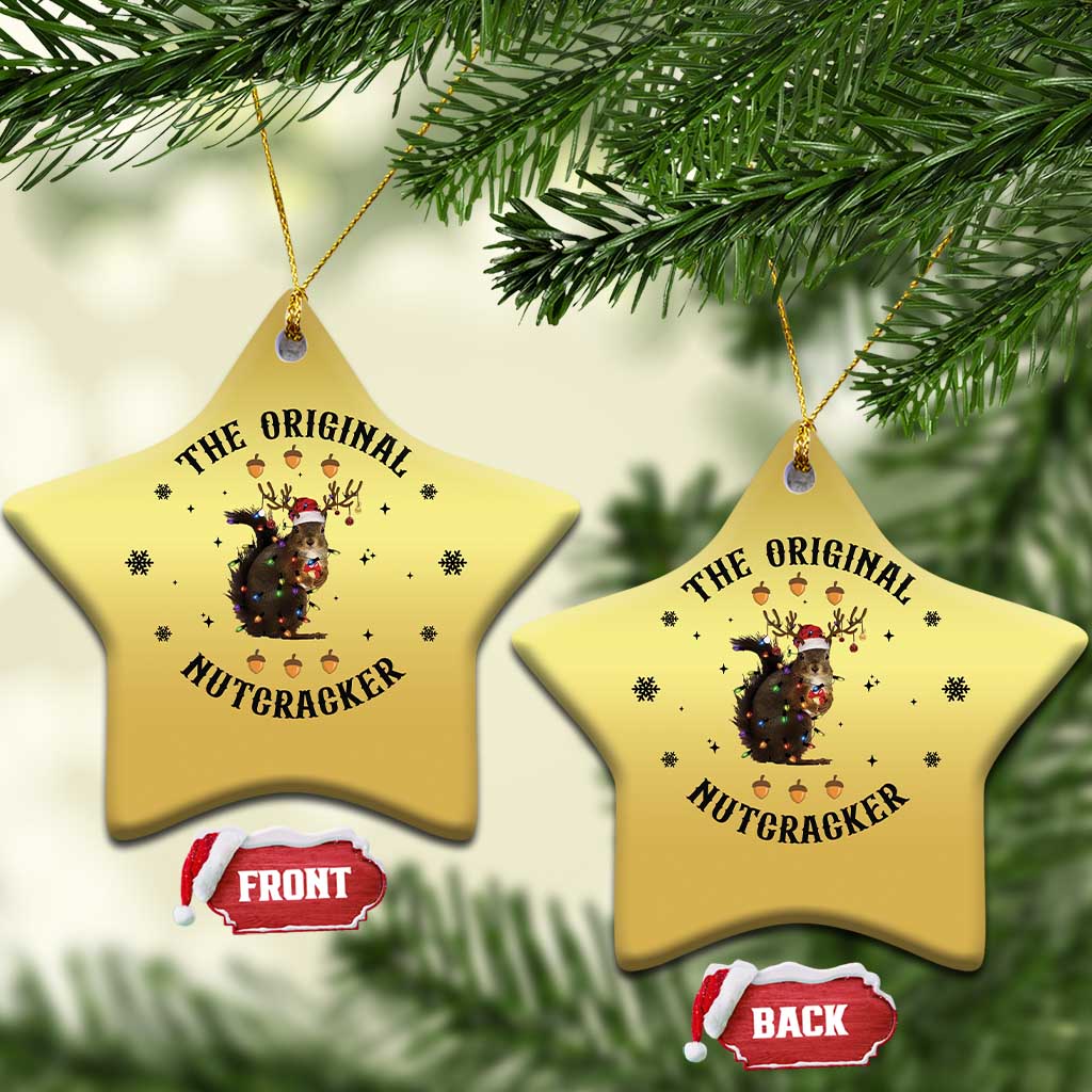 Gold star-shaped Christmas ornament with nutcracker squirrel graphic, two hanging.