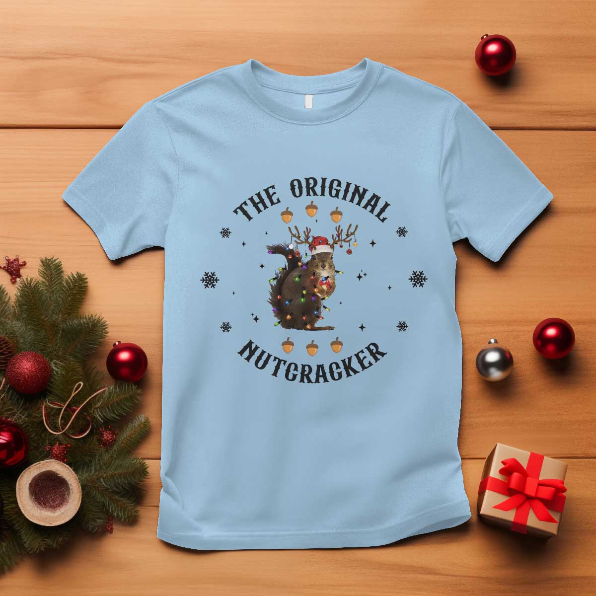 Light blue crew-neck T-shirt with “The Original Nutcracker” squirrel graphic.