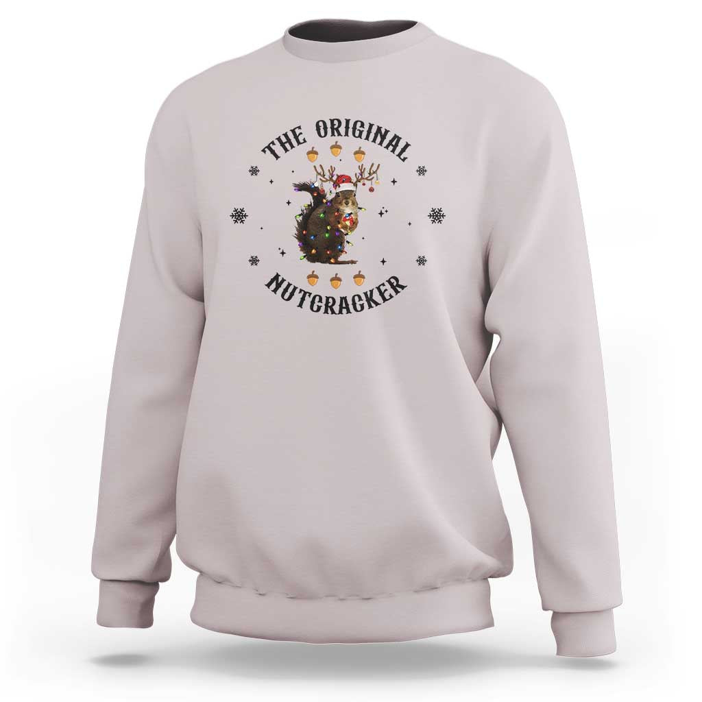 Light gray crewneck sweatshirt with nutcracker graphic and winter snowflake accents