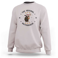 Light gray crewneck sweatshirt with nutcracker graphic and winter snowflake accents