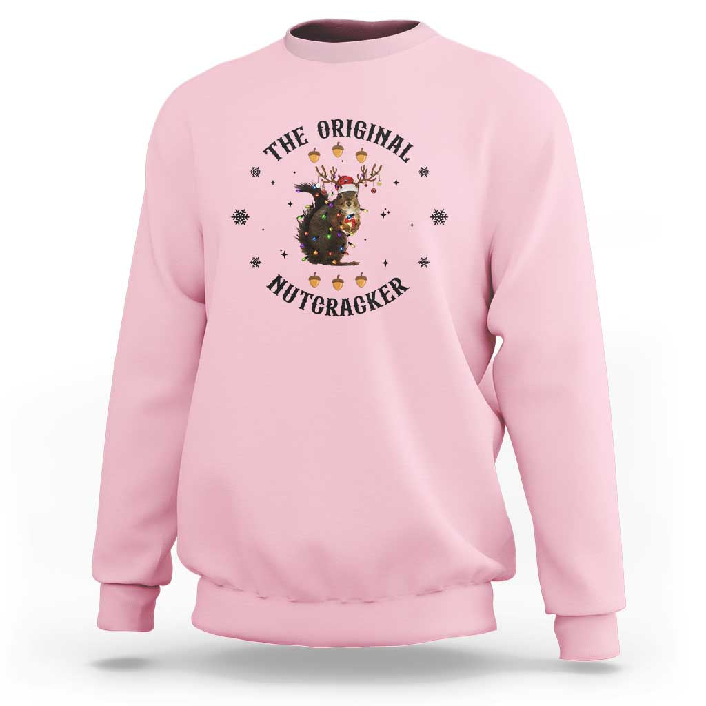 Light pink crewneck sweatshirt with nutcracker graphic and winter snowflake accents