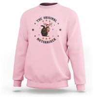 Light pink crewneck sweatshirt with nutcracker graphic and winter snowflake accents