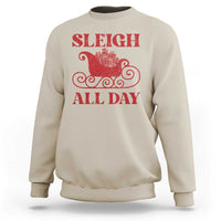 Sand-colored crewneck sweatshirt with red “SLEIGH ALL DAY” sleigh graphic