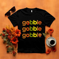 Black funny Thanksgiving t-shirt with “gobble gobble” text and turkey graphic