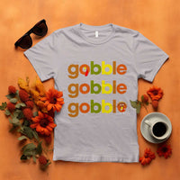 Light gray funny Thanksgiving t-shirt with “gobble gobble” text and turkey graphic