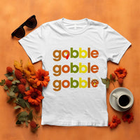 White funny Thanksgiving t-shirt with “gobble gobble” text and turkey graphic