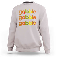 Light gray sweatshirt with “gobble gobble gobble” text and small turkey graphic on chest