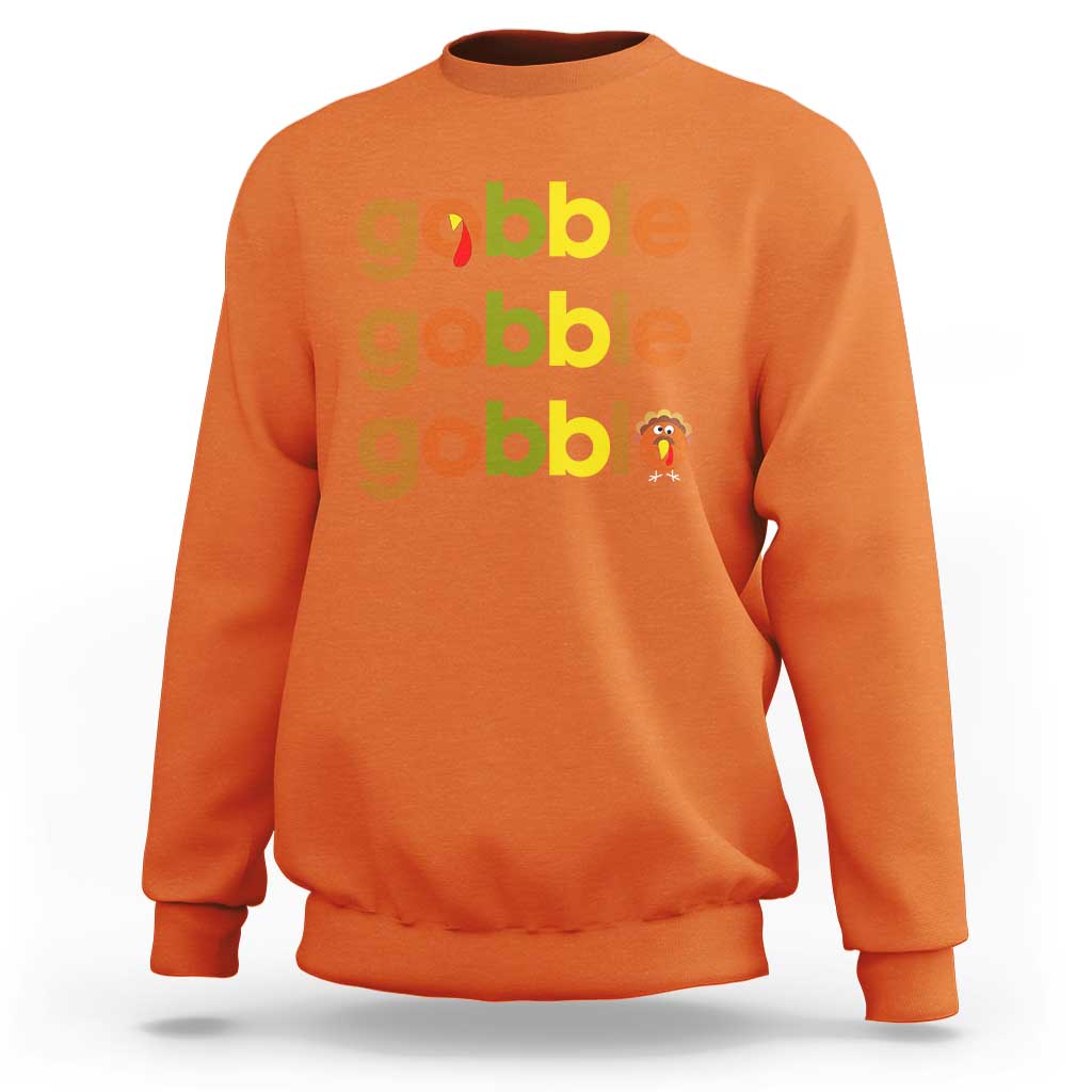 Orange sweatshirt with “gobble” text and small turkey graphic on chest
