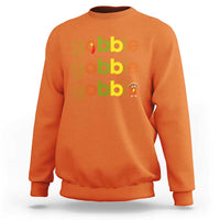 Orange sweatshirt with “gobble” text and small turkey graphic on chest