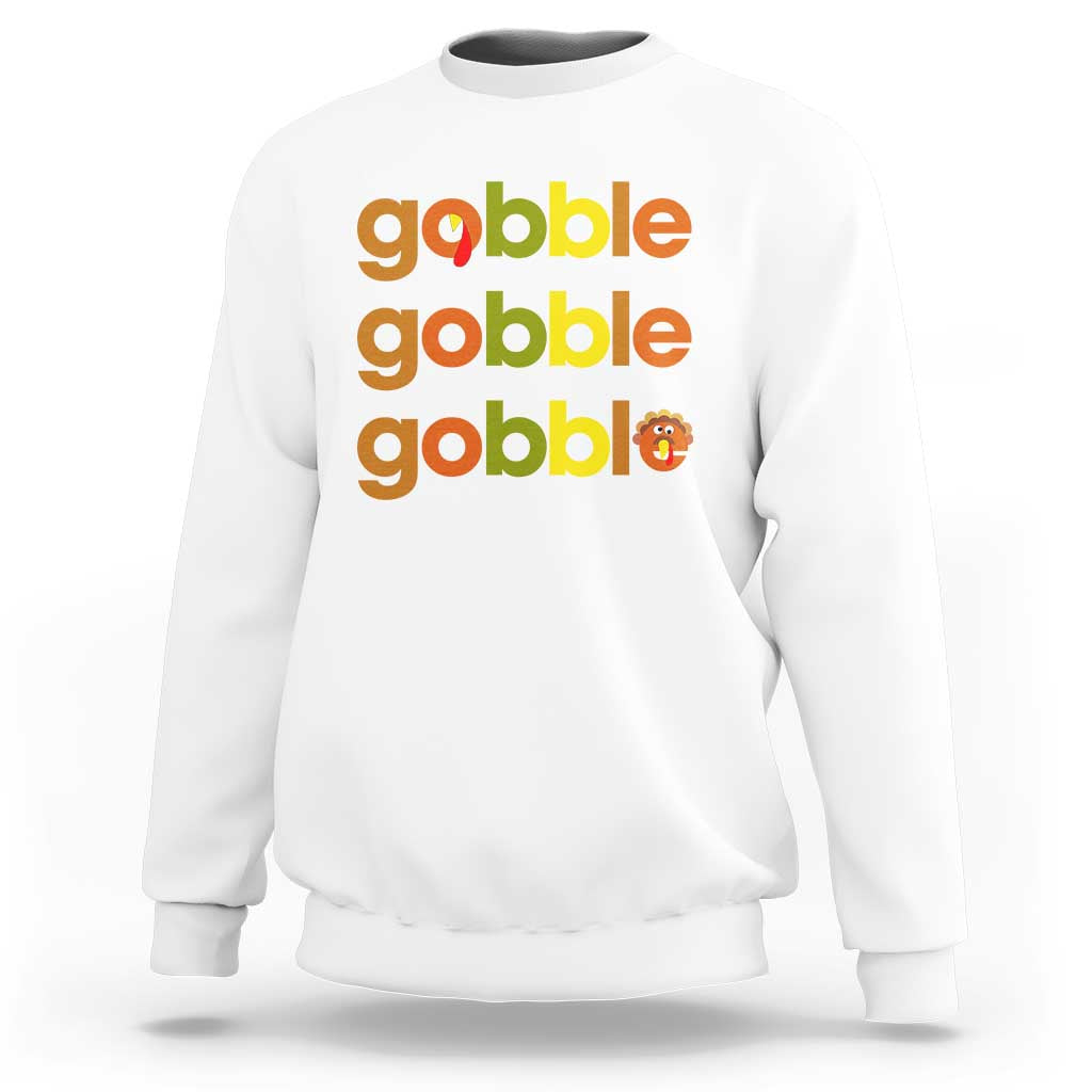White sweatshirt with “gobble gobble gobble” text and small turkey graphic on chest