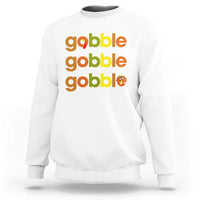 White sweatshirt with “gobble gobble gobble” text and small turkey graphic on chest