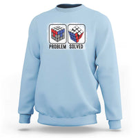 Light blue crewneck sweatshirt with “Problem Solved” puzzle cube graphic