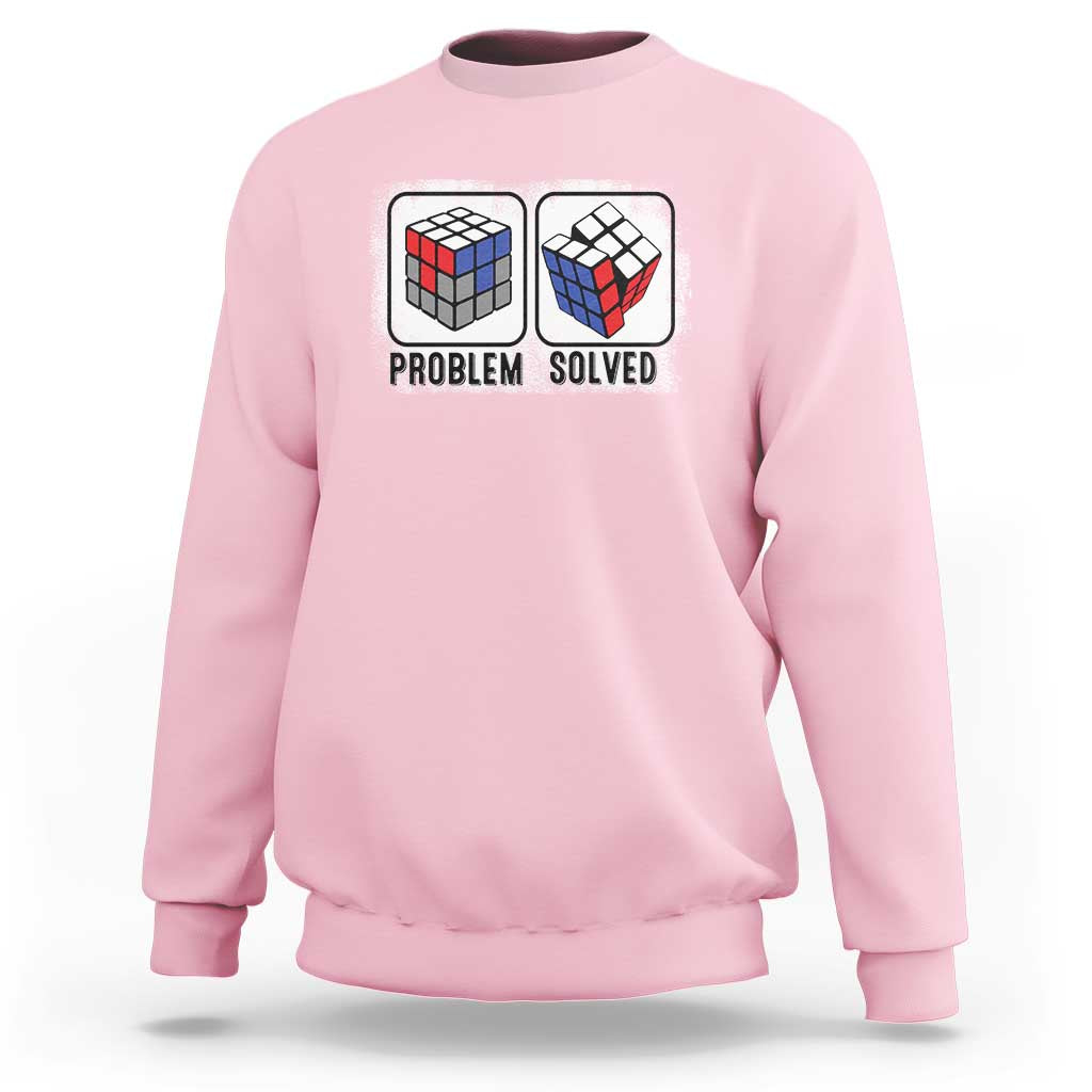 Light pink crewneck sweatshirt with “Problem Solved” puzzle cube graphic