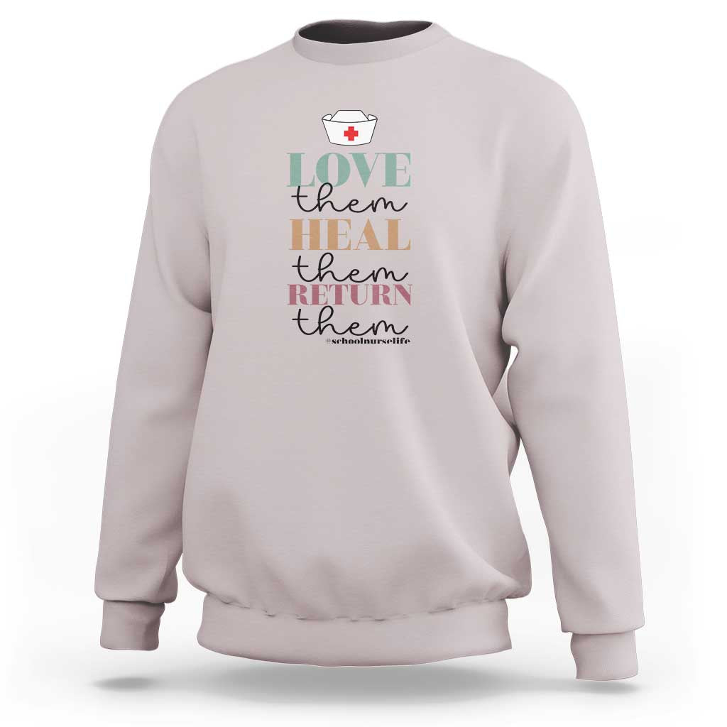 Light gray crewneck sweatshirt with 'Love heal return them' nurse heart graphic