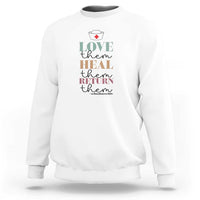 White crewneck sweatshirt with 'Love heal return them' nurse heart graphic