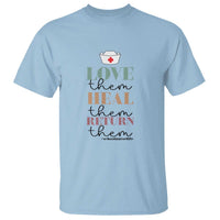 Light blue school nurse T-shirt with “Love them Heal them Return them” graphic and medical cross