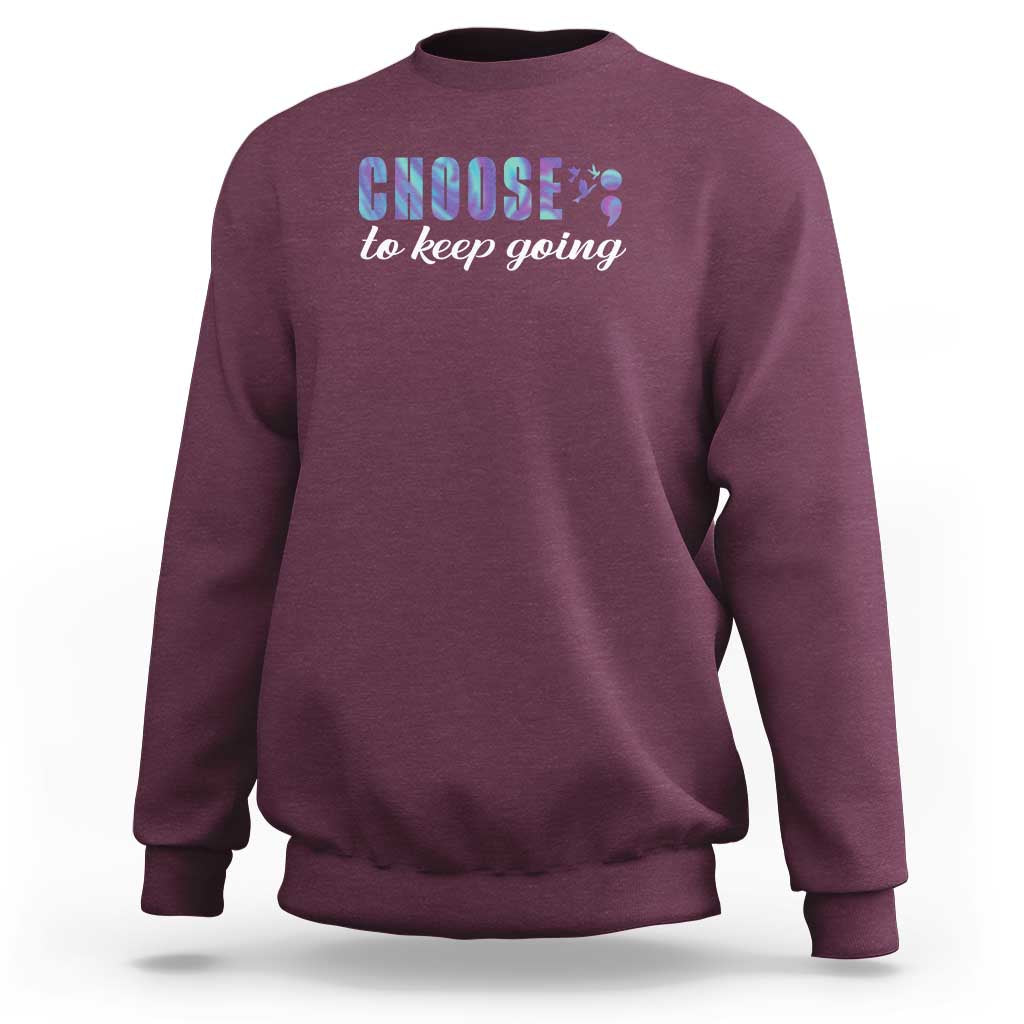 Maroon crewneck sweatshirt with front “choose to keep going” colorful graphic.