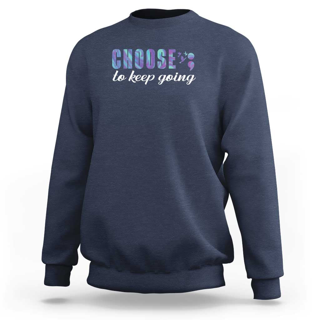 Navy crewneck sweatshirt with front “choose to keep going” colorful graphic on chest.