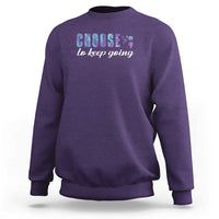 Purple crewneck sweatshirt featuring a front “choose to keep going” colorful graphic.