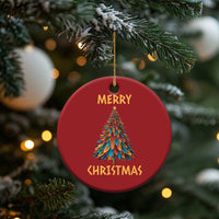 Red round Christmas ornament with colorful tree graphic and "Merry Christmas" lettering