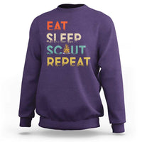 Purple crewneck sweatshirt with “EAT SLEEP SCOUT REPEAT” graphic