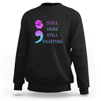 Black crewneck sweatshirt with “STILL HERE STILL FIGHTING” graphic and semicolon symbol