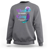 Charcoal gray crewneck sweatshirt with front rose-feather awareness graphic.