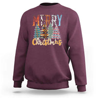 Maroon crewneck sweatshirt with 'Merry Christmas' and multicolor tree graphic.