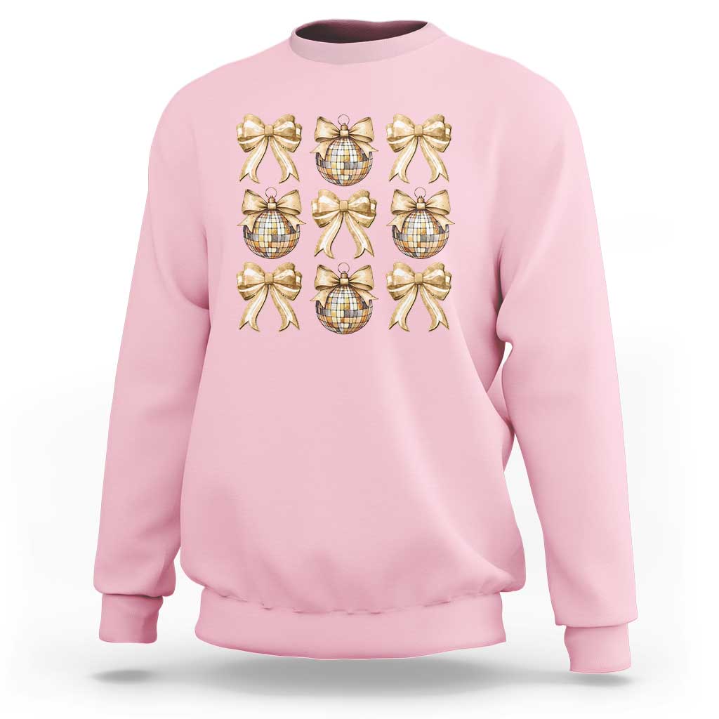 Light pink sweatshirt with gold bow and plaid ornament graphic on front