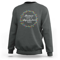 Charcoal gray sweatshirt with circular Christmas lights graphic and text at the chest