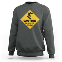 Dark heather gray crewneck sweatshirt with yellow “CAUTION PRAY FOR SNOW” graphic