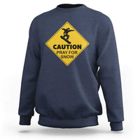 Navy crewneck sweatshirt with yellow “CAUTION PRAY FOR SNOW” snowboard graphic