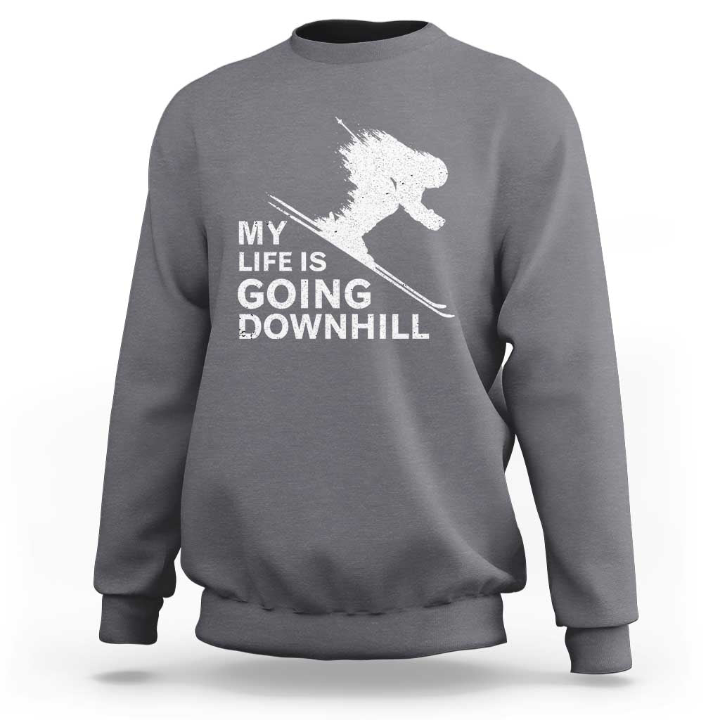Charcoal gray skiing sweatshirt with white skier graphic and slogan "My life is going downhill".