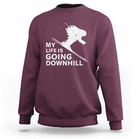Maroon skiing sweatshirt with white skier graphic and slogan "My life is going downhill".