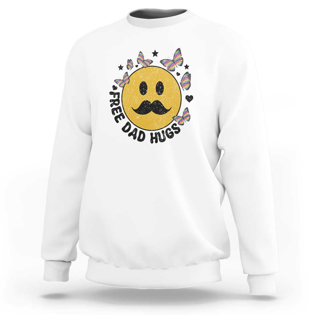 White crewneck sweatshirt with smiling face graphic and “FREE DAD HUGS” text